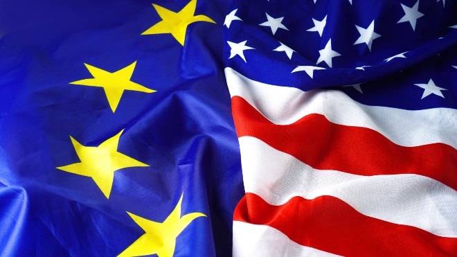 An EU and US flag lying together.