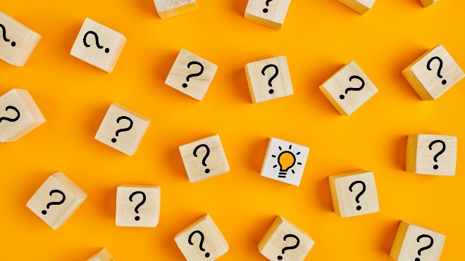 An orange tabletop with wooden question mark blocks laid upon it.