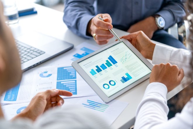 Consultants analysing PMCF data on a tablet