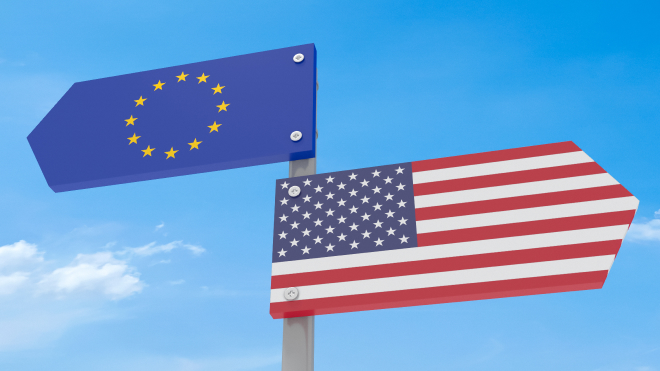 US and EU flag signposts pointing in different directions